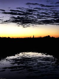 Scenic view of silhouette landscape against sky at dusk