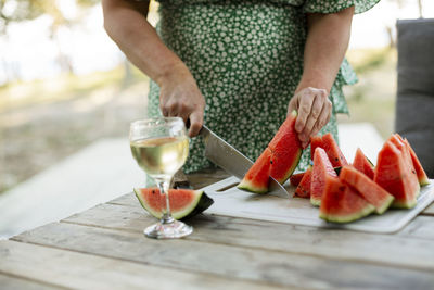 Woman cutting watermelon