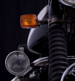 Close-up of motorcycle against black background