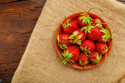 High angle view of strawberries in bowl on table