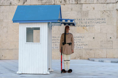 Rear view of man standing by building