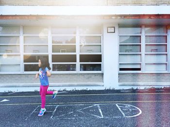 Girl standing in front of house