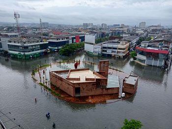 High angle view of river amidst buildings in city