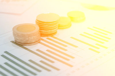 Close-up of stack coins on graph paper