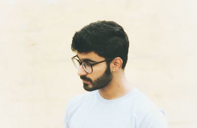 Man in eyeglasses standing at beach