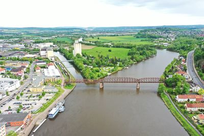 High angle view of bridge over river amidst buildings in city