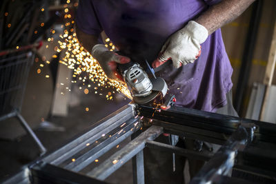 Midsection of man working in factory