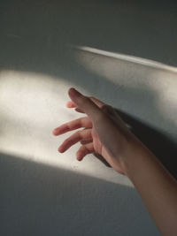 Close-up of hand touching wall