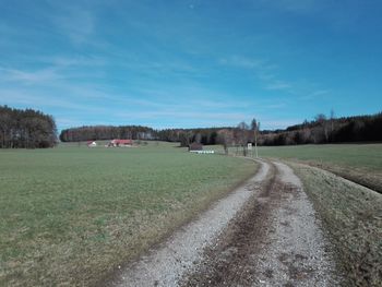 Scenic view of land against blue sky