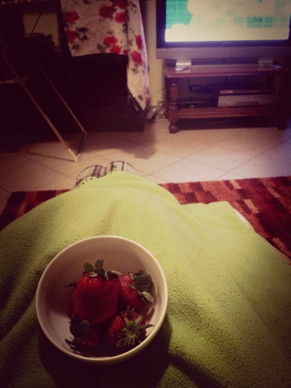 indoors, table, food and drink, high angle view, freshness, still life, plate, food, home interior, red, no people, flower, flooring, close-up, sweet food, elevated view, tablecloth, tiled floor, day, decoration