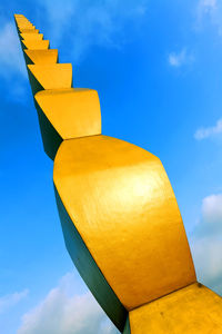 Low angle view of the endless column sculpture against blue sky