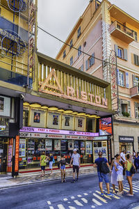 People walking on street against buildings in city