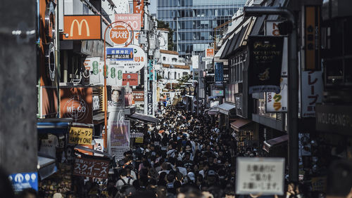 High angle view people on street amidst buildings in city