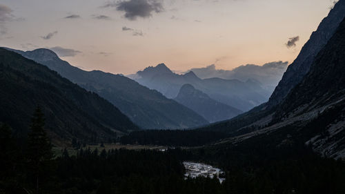 Scenic view of mountains against sky at sunset