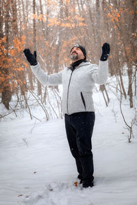 Full length of person standing on snow covered field