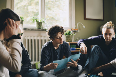 Group of people sitting at home