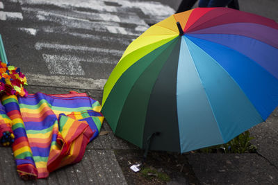 Multi colored umbrella on footpath