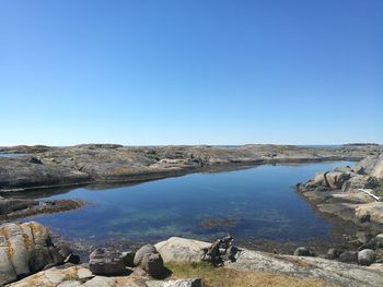 Scenic view of sea against clear blue sky