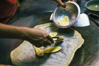 Cropped hand of man preparing food