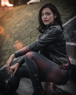 Portrait of young woman sitting on steps