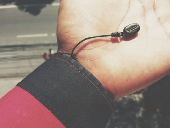 Cropped image of hand holding artificial coffee bracelet