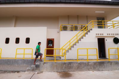 Low angle view of man walking on staircase