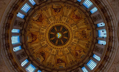 Directly below shot of illuminated ceiling in church