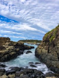 Scenic view of waterfall against sky