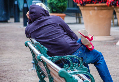 Rear view of man sitting outdoors