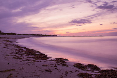 Scenic view of sea against sky at sunset