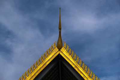 Low angle view of yellow building against sky