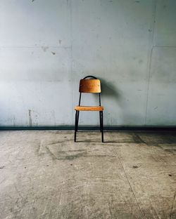 Empty chairs against wall