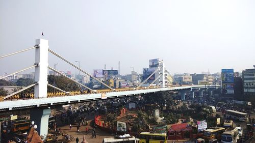 Bridge in city against clear sky