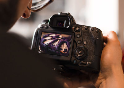 Close-up of woman holding camera