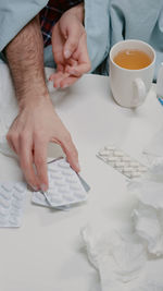 Midsection of man working on table