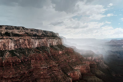 View of cliff against cloudy sky