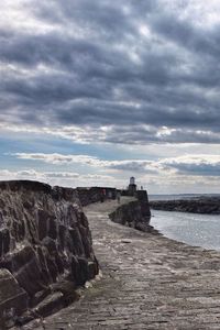 Scenic view of sea against cloudy sky