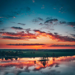 Scenic view of lake against romantic sky at sunset