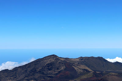 Scenic view of mountains against clear blue sky