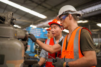 Portrait of male worker standing in the heavy industry manufacturing factory.