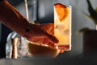 Cropped hand of woman holding light bulb