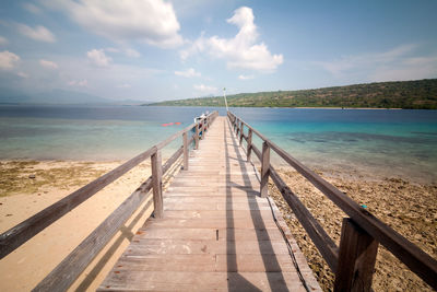 Pier over sea against sky