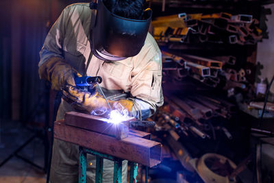 Welder welding in workshop