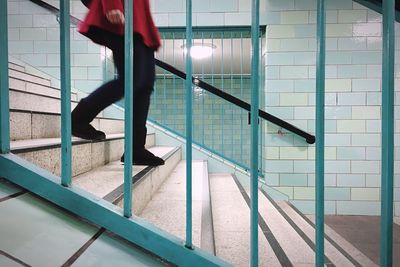 Woman standing on escalator