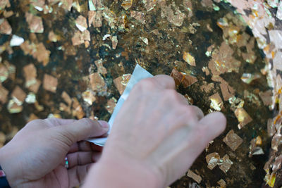 Midsection of person holding rock