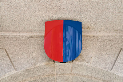 High angle view of red umbrella on blue wall