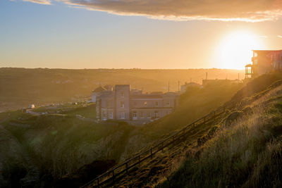 Panoramic shot of buildings against sky during sunset