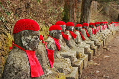 Sculptures with red knitted hat at nikko national park