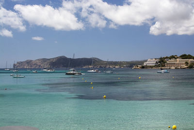 Sailboats on sea against sky