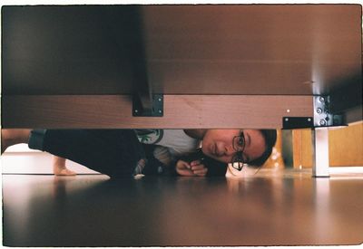 Portrait of man sitting on table